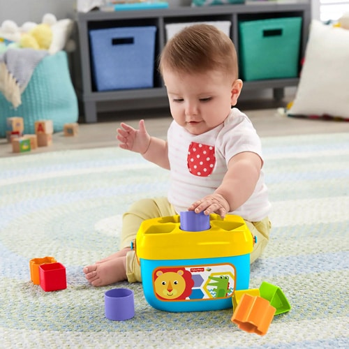 baby playing with Fisher Price - Baby's First Blocks