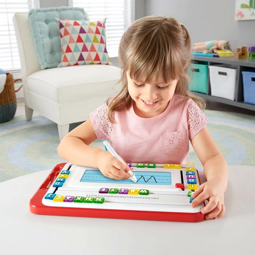 kid writing on the Fisher Price – Think & Learn – Alpha Slidewriter