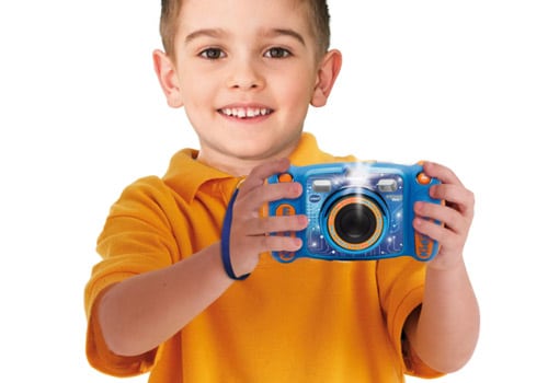 boy holding his blue Kidizoom Print Cam