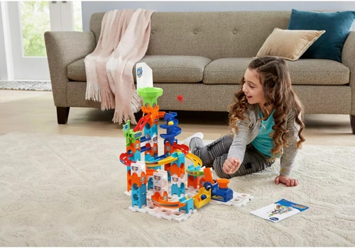 young child playing with a Vtech Marble Rush set
