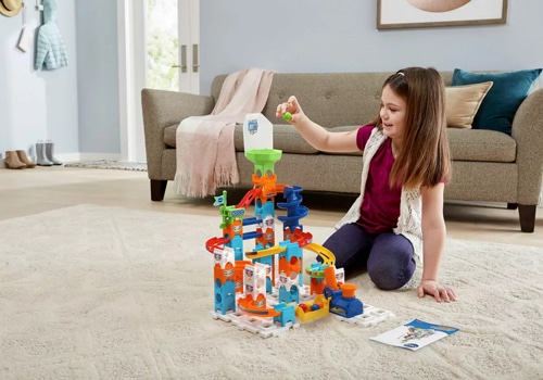 young girl playing with Vtech Marble Rush set