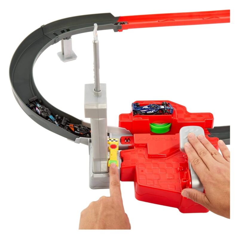 Hands pressing the pedal and launch button at the starting line with cars ready to race.