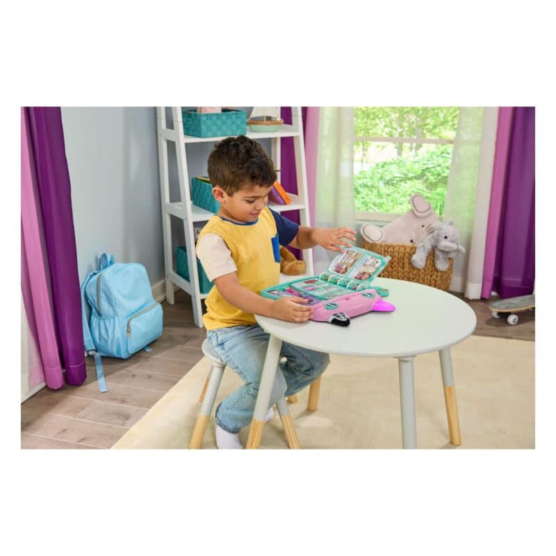 Boy at table using VTech Gabby’s Dollhouse Cat-a-Vator Discovery Book