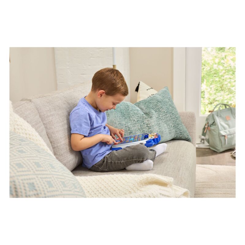 Boy sitting on sofa using VTech PAW Patrol Light-Up Missions Pup Pad