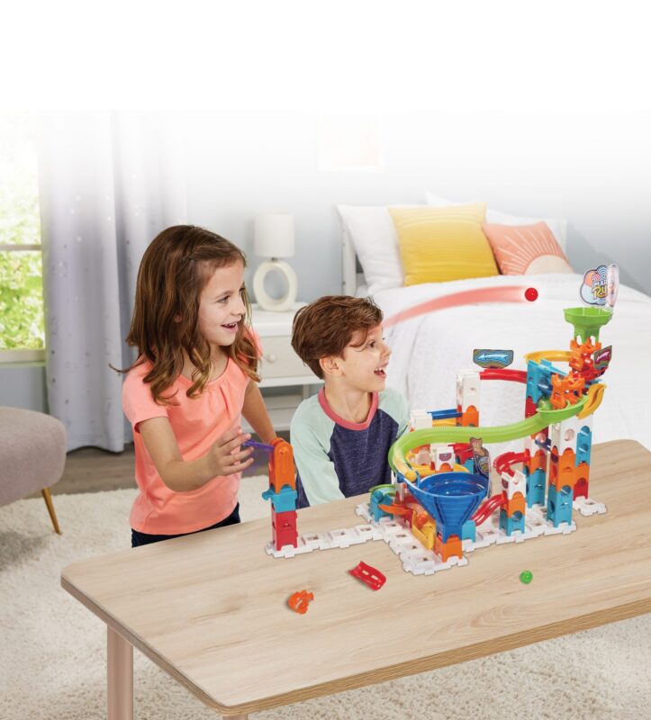 Two children playing with the VTech Marble Rush Play Zone marble run set on a table