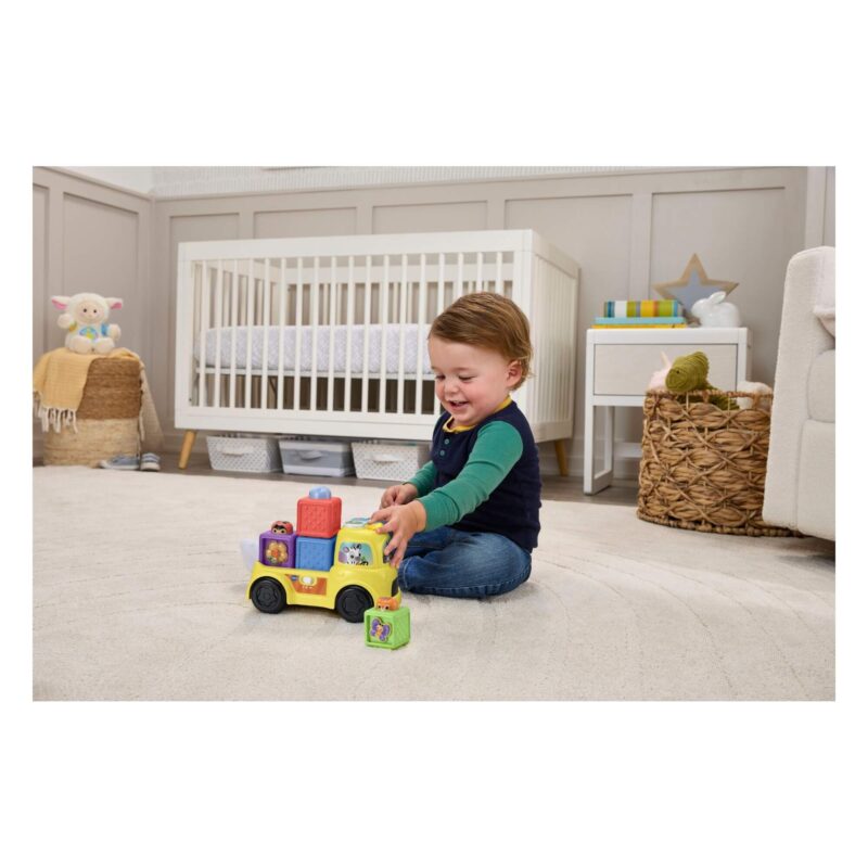 Toddler pushing VTech Baby Pop-a-Block Truck with blocks