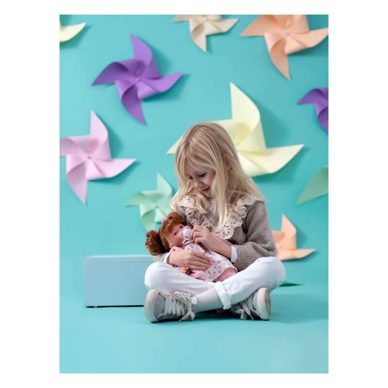 Child cuddling Llorens Lea 33cm crying doll during playtime