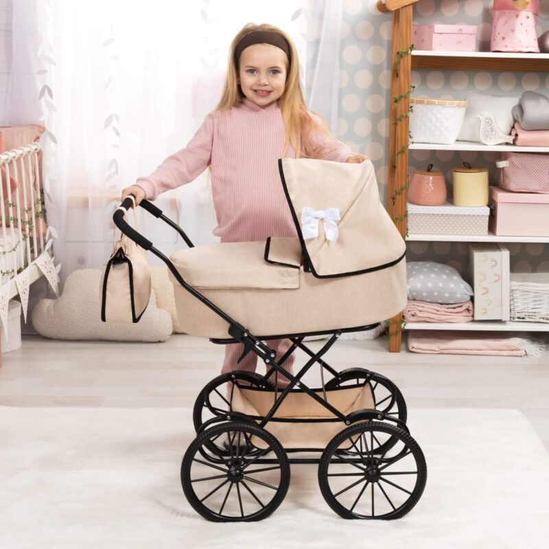 Child playing with Bayer Design Doll Pram Classic beige with black trim and white bow