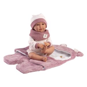 Mimi doll sitting on mauve plush blanket