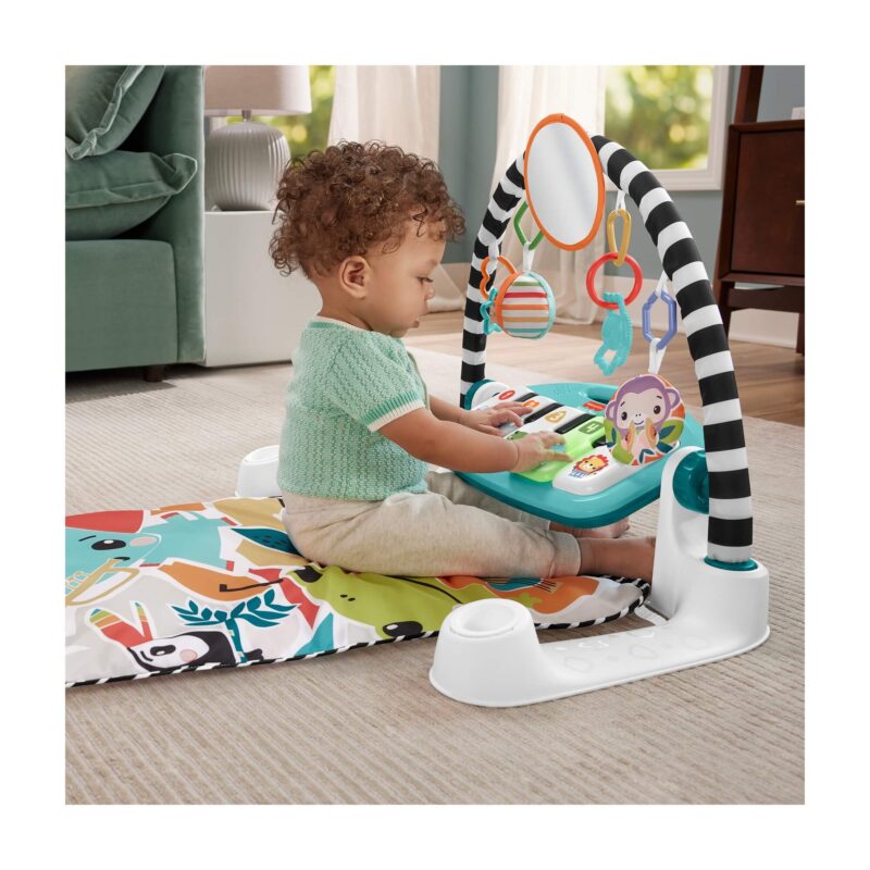 Baby sitting and pressing blue piano keys