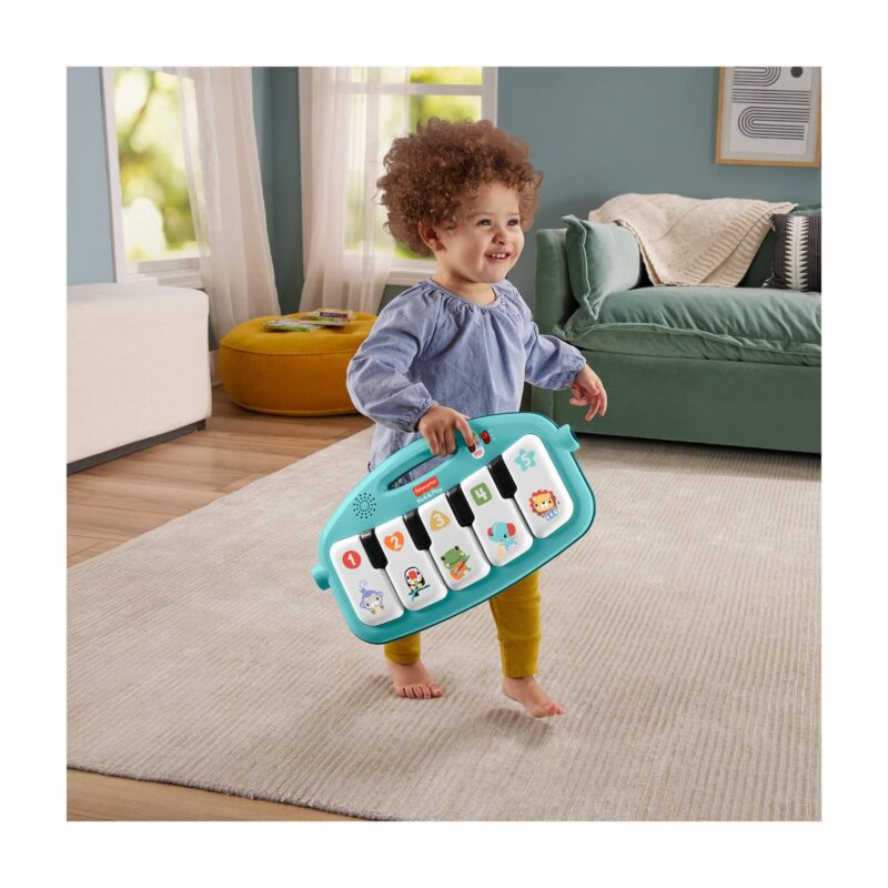 Toddler carrying removable Fisher-Price piano