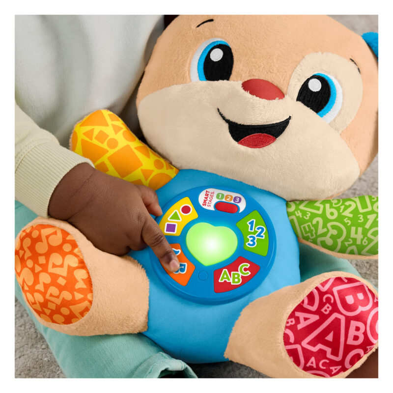 Baby pressing glowing heart button on Smart Stages Puppy