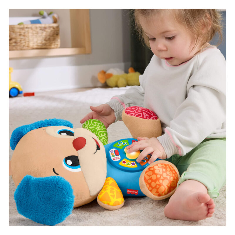 Toddler playing with musical Smart Stages Puppy toy