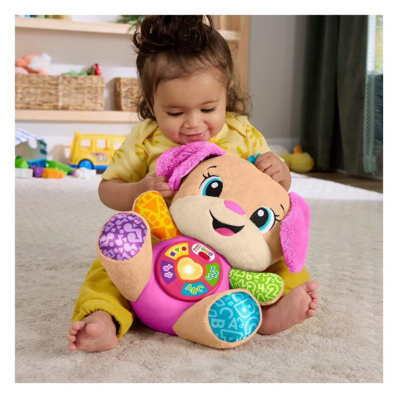 Toddler hugging Fisher-Price Smart Stages Sis pink musical plush toy