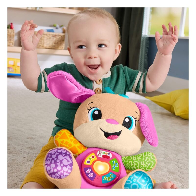 Smiling baby playing with Fisher-Price Laugh & Learn Smart Stages Sis pink plush