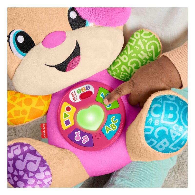 Baby pressing light-up tummy buttons on Fisher-Price Sis pink toy
