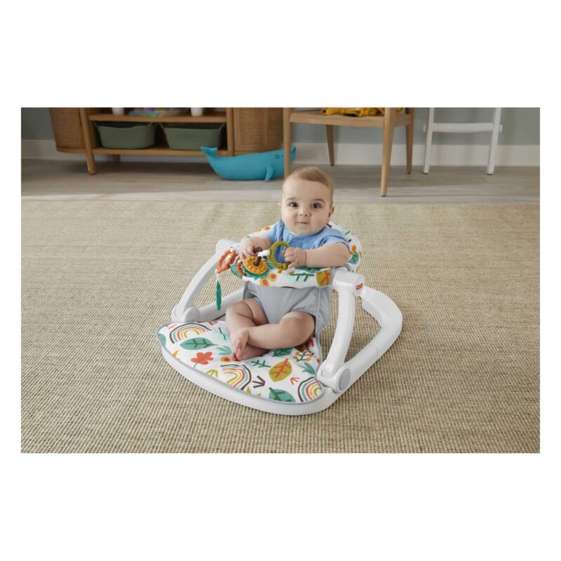 Baby sitting and playing with toys in Fisher-Price Sit-Me-Up Floor Seat