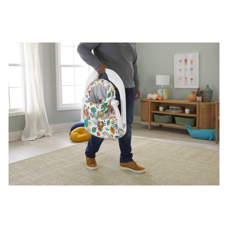 Fisher-Price Sit-Me-Up Floor Seat folded flat and carried by a parent