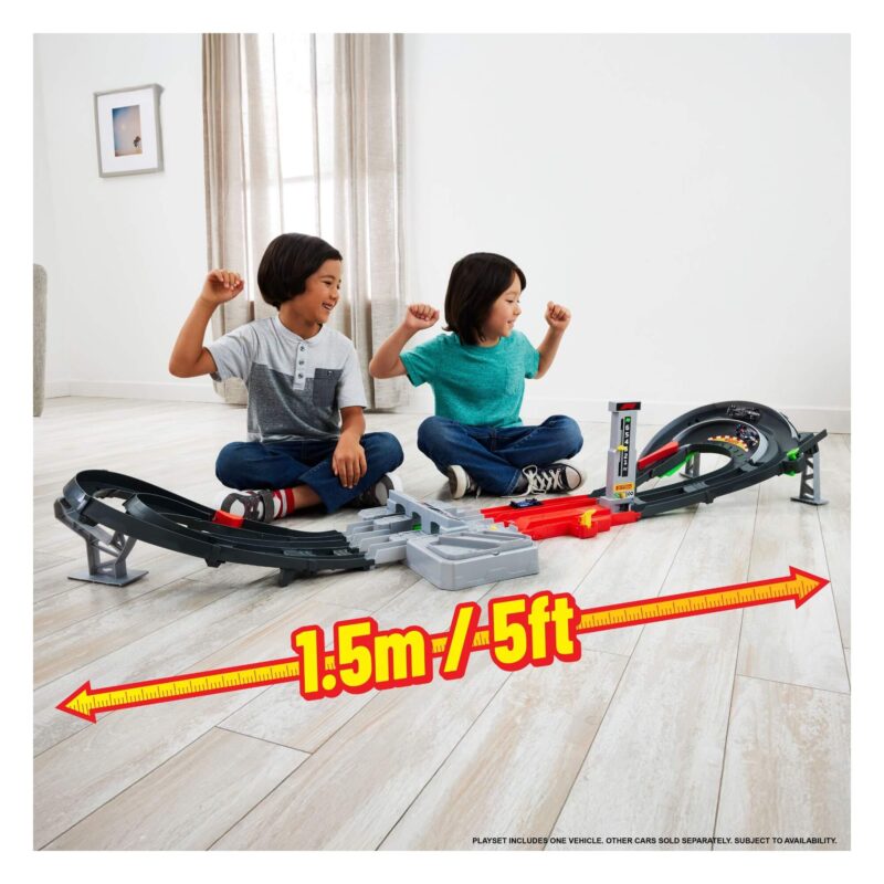 Kids racing with Hot Wheels Formula 1 Grand Prix Circuit playset