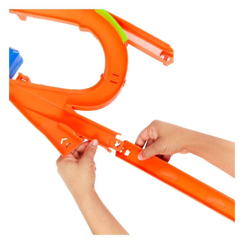 Hands connecting bright orange Hot Wheels track