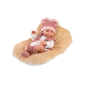 Llorens Baby Doll Nica Nacinda resting on a beige cushion in pink knitted outfit